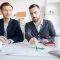 Portrait of real estate agent helping client choosing house in agency